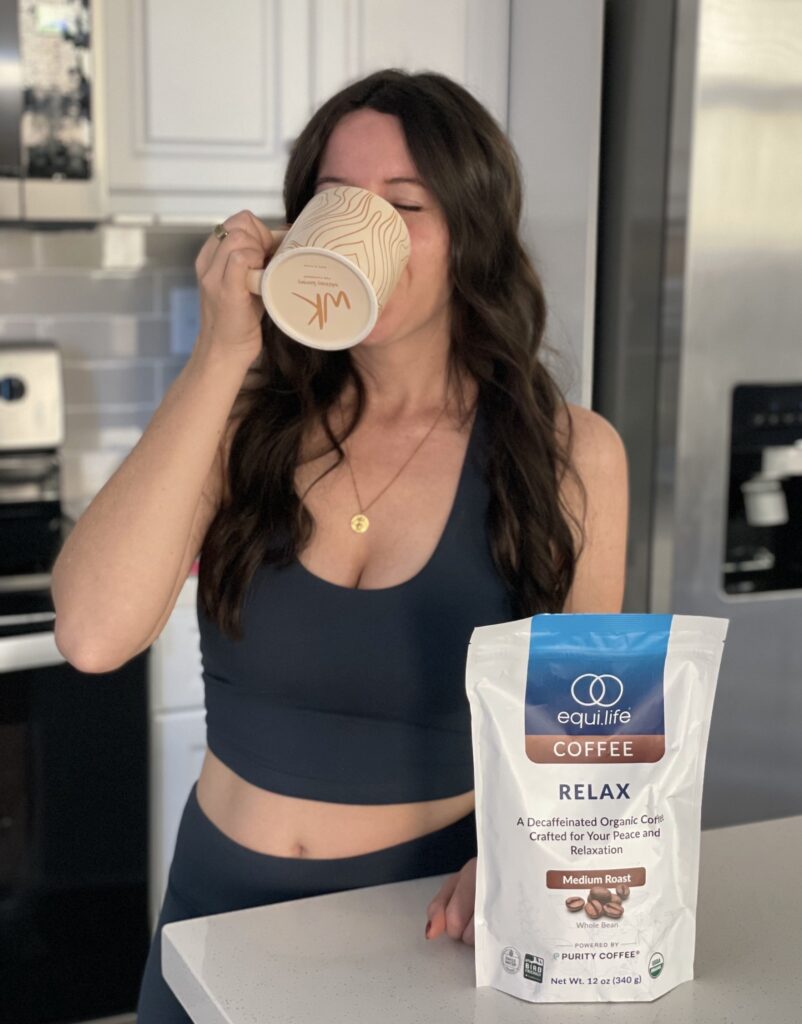 Woman drinking out of coffee mug.